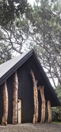 A wooden chapel for the Holy See | © Alessandra Chemollo A small chapel made of dark wood surrounded by trees | © Alessandra Chemollo